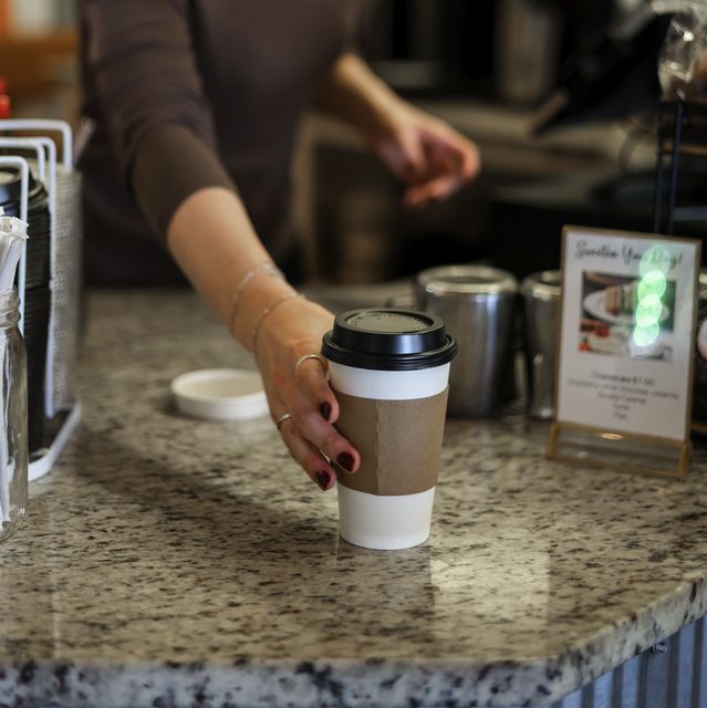 A to-go coffee cup on the granite counter, ready to pick up